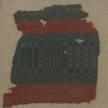 a green cloth with a check style pattern with alternating wide and narrow checks in light and dark green