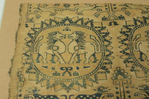 A phioto of one half the design with the horses facing each other in a spickey circle