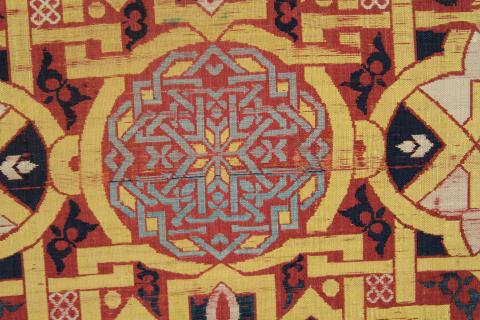 Closeup of geometric design in blue, red, yellow, and silver