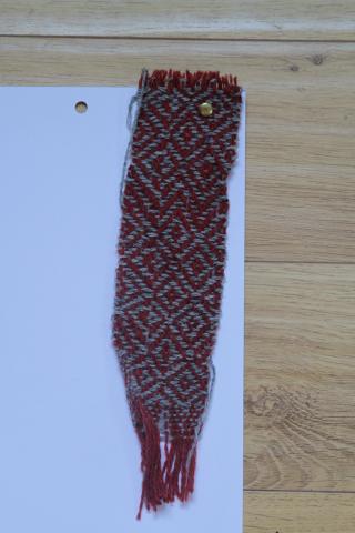 red cloth with grey diamonds woven in